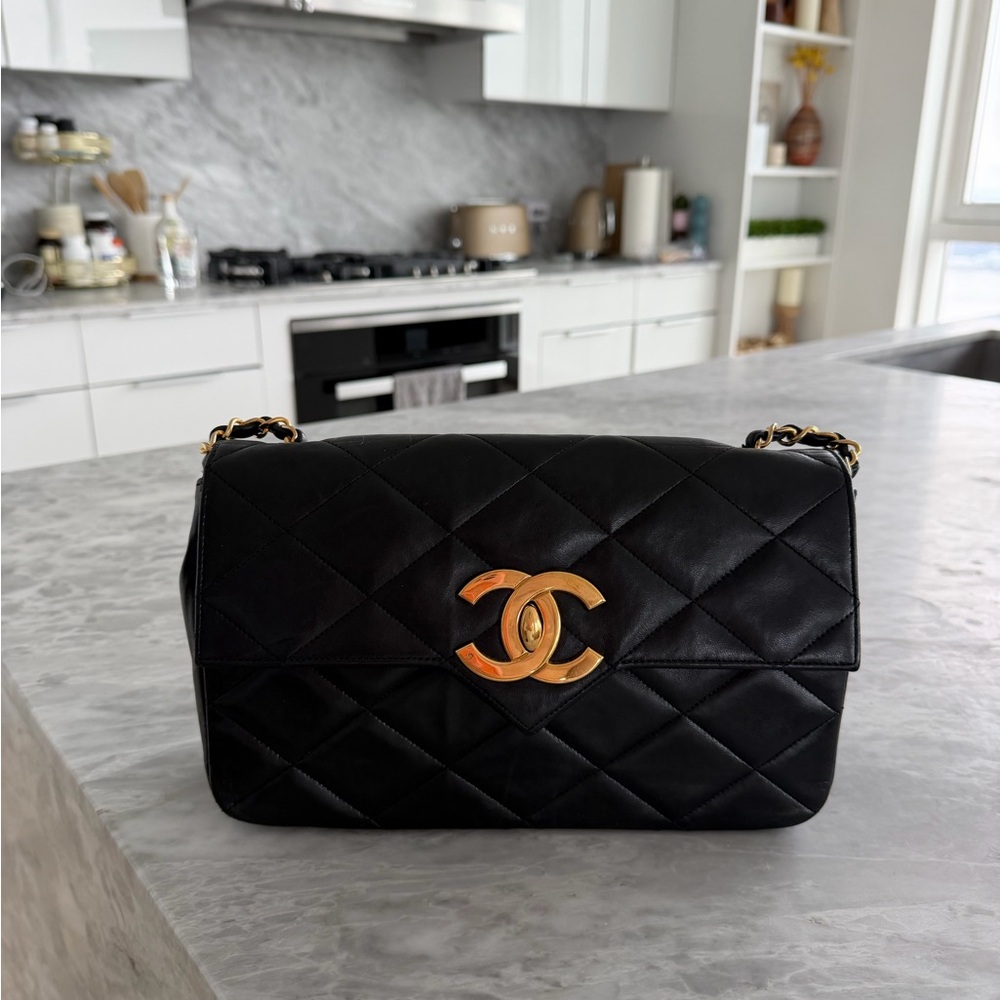 CHANEL Black Quilted Shoulder Bag with Gold CC Lock